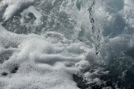 Water and waterdrops splashing down from a fountain.の写真素材