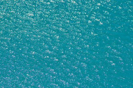 Bright shiny pattern of sun bouncing off the surface of a pool.の写真素材