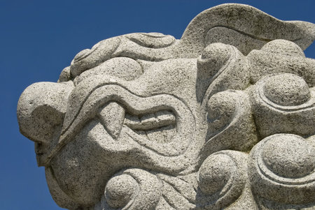 A growling lion guarding a temple in Seoul, Korea.の写真素材