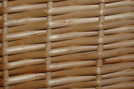 woven rattan strips to form a basket