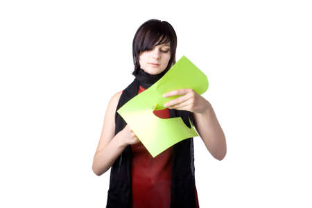 The young beautiful businesswoman at office behind work on a white backgroundの写真素材