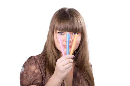 The young beautiful businesswoman at office behind work on a white backgroundの写真素材