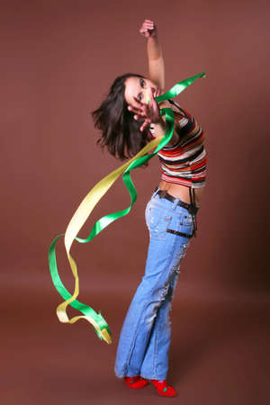 The young beautiful girl during active leisure on a color backgroundの写真素材