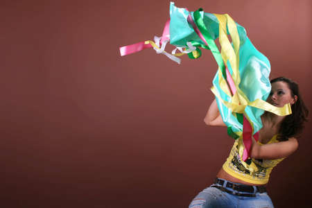 The young beautiful girl during active leisure on a color backgroundの写真素材