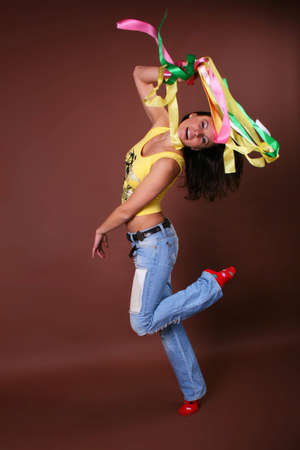 The young beautiful girl during active leisure on a color backgroundの写真素材