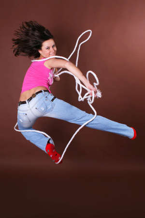 The young beautiful girl during active leisure on a color backgroundの写真素材