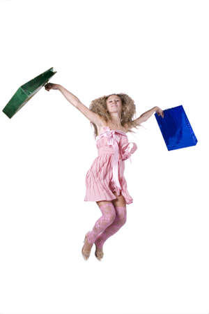 The young beautiful girl with purchases in colour packages during shopping on a white backgroundの写真素材