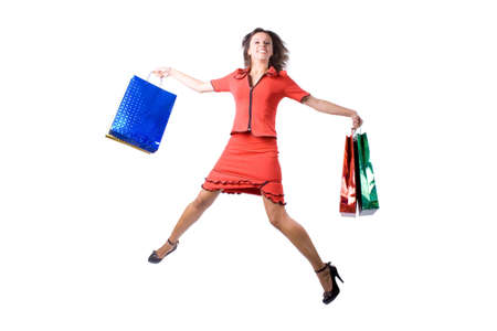 The young beautiful girl with purchases in colour packages during shopping on a white backgroundの写真素材