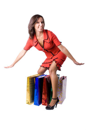 The young beautiful girl with purchases in colour packages during shopping on a white backgroundの写真素材