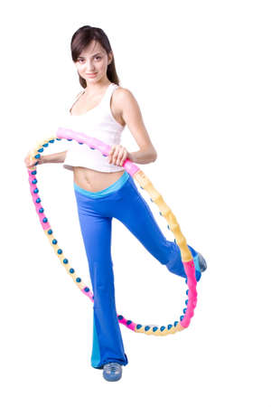 The young girl engaged in fitness on a white backgroundの写真素材