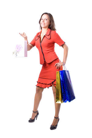 The young beautiful girl with purchases in color packages during shopping on a white backgroundの写真素材