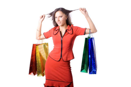 The young beautiful girl with purchases in color packages during shopping on a white backgroundの写真素材