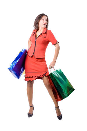 The young beautiful girl with purchases in color packages during shopping on a white backgroundの写真素材