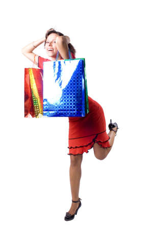 The young beautiful girl with purchases in color packages during shopping on a white backgroundの写真素材