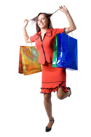 The young beautiful girl with purchases in color packages during shopping on a white backgroundの写真素材