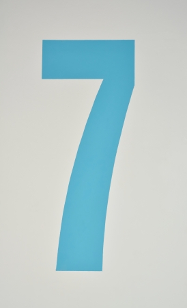 Number seven painted in blue on a wallの写真素材