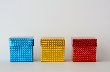 Three boxes of colors, blue, yellow, red with white backgroundの写真素材