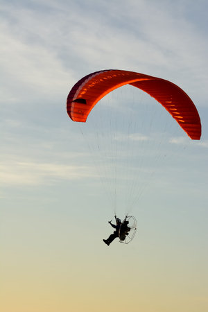 The silhouette of a man playing sports flight