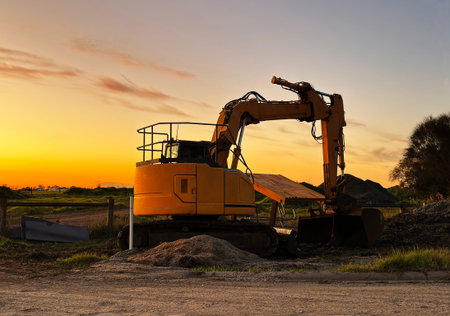 Excavator working on a construction site at sunset in Australia.