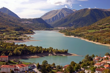 pretty mountain town on a lake in the italian Abruzzoの写真素材