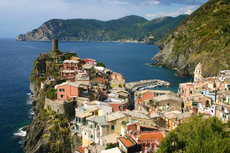 colorful houses piled on a rocky nose on the coast line の写真素材