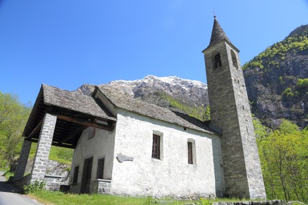 cute, little church built from stone standing amidst fresh spring green in a mountain valley in Ticino,Switzerland の写真素材