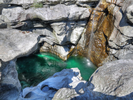 green water of deep cut gorge of river maggia near Locarno Switzerland called Ponte Brollaの写真素材
