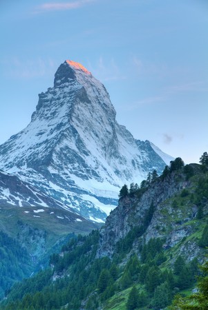 famous swiss iconic mountain Matterhorn at sunset with it's top still blazing readの写真素材
