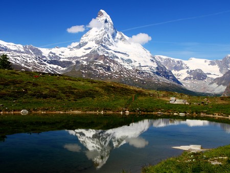 famous mountain Matterhorn on a beautiful summer day reflects in the water of a mountain lakeの写真素材