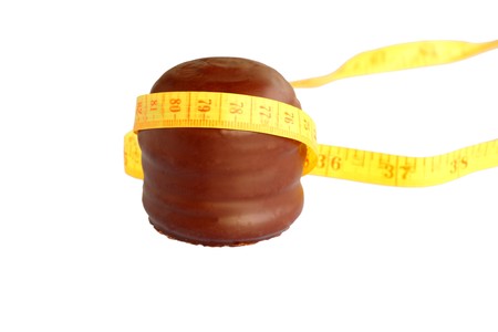 isolated on white  chocolate foam kiss aka chocolate covered marshmallow, wrapped with a tape measure, concept for temptation,giving in to your cravings,diet,discipline,willpower,slim, loose weight, gain weightの写真素材