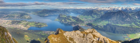 Long panorama of whole lake Lucerne framed by high alpine mountains on a summer day, Switzerlandの写真素材