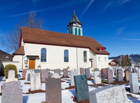 graveyard with small church on a sunny winter dayの写真素材