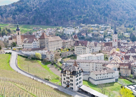 historic city center with church, castle  and old houses surrounded by vinyards and mountains in Chur, Switzerlandの写真素材
