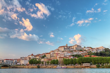 Old town of coimbra glows at sunset under a pretty summer sky, Portugalの写真素材