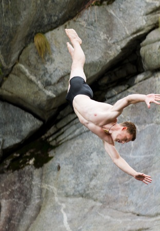 LOCARNO - JULY 23: Cliff diving athlete Andy Hulliger competes in the WHDF European Championship 2011 with dives from up to 20m high at Ponte Brolla July 23, 2011 in Locarno, Switzerland.のeditorial素材