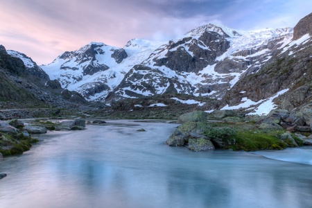 Swiss alpine mountain glacier melt river near Susten pass at sunset, Switzerlandの写真素材