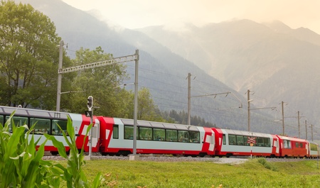 Glacier express train passes high mountain valley, Switzerlandのeditorial素材
