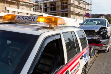 AFFOLTERN, SWITZERLAND-SEPTEMBER 15: Front car crash wreck sits on trailer at roadside to be hauled off by Autohilfe  in Affoltern, SUI on September 15, 2011. のeditorial素材