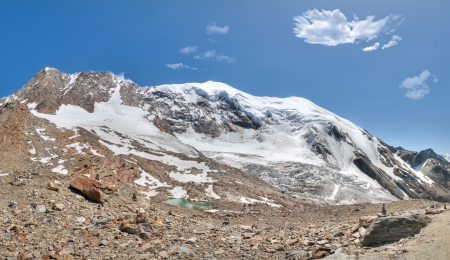  mountain range with rock cairn marking and glacier above Saas Fee valley, Switzerlandの写真素材