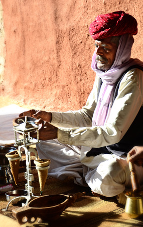 Rajasthan  India   february 10th  an unidentified man is doing a traditional opium ceremony in rajasthan, india on february 10th 2012 のeditorial素材
