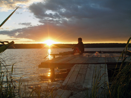 Silhouette of lonely man at sunset.の写真素材