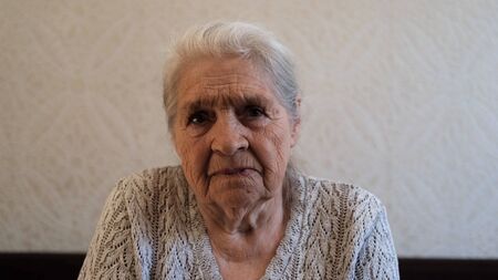 Portrait of an elderly gray-haired serious woman.の写真素材