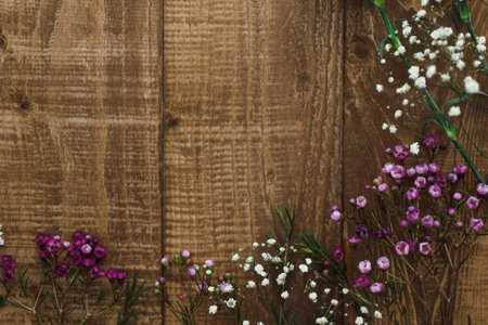 Flowers on a wooden background with space for text. Top viewの写真素材