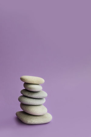 Stacked zen stones on a purple background. Zen concept.の写真素材