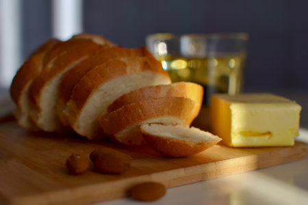 Bread and butter on a cutting board. Selective focus.の写真素材