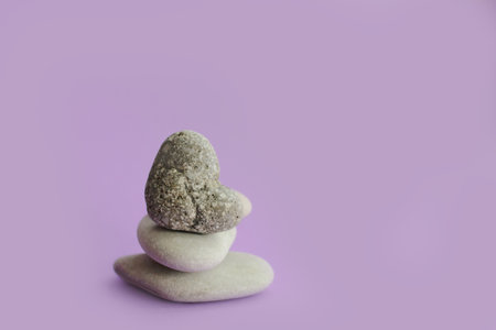 Spa stones on a purple background. Zen concept. Copy space.の写真素材