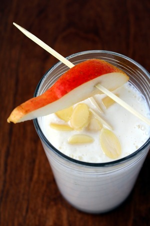 White smoothie made with pear yogurt and almondの写真素材