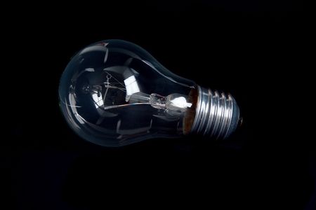 Classic light bulb isolated on black backgound.の写真素材