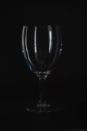 Empty wine glass isolated on black background.の写真素材