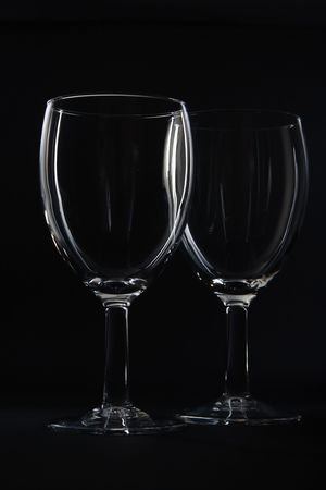 Two empty wine glasses isolated on black background.の写真素材